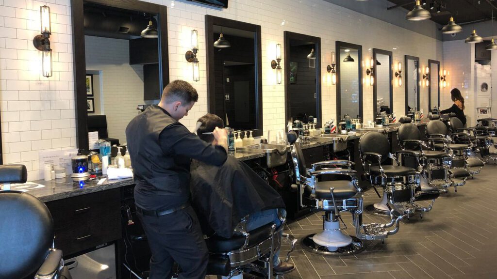 A barber cutting a clients hair