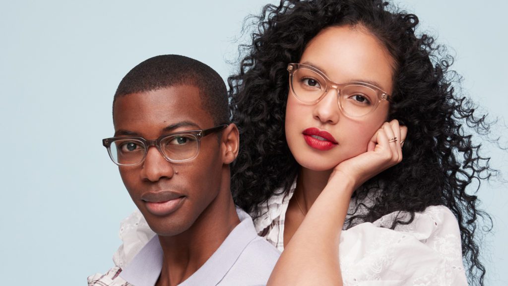 A man and woman pose with glasses